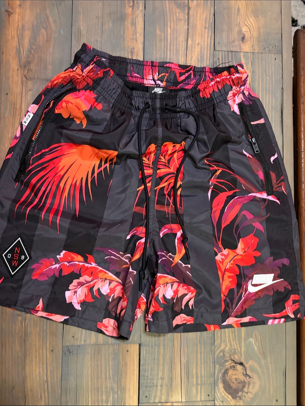Nike Men's Black Shorts with Red and Pink Tropical Print